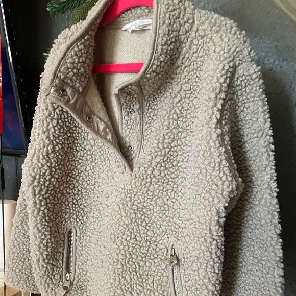 A warm unisex tan-ish brown pullover sweater with two front zipper pockets. - Picture 1 of 4
